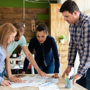 Equipo de 4 personas (hombres y mujeres) trabajando en un proyecto común.